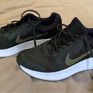Nike running shoes with black with logo on sides of shoes. Never been worn. NWOT
